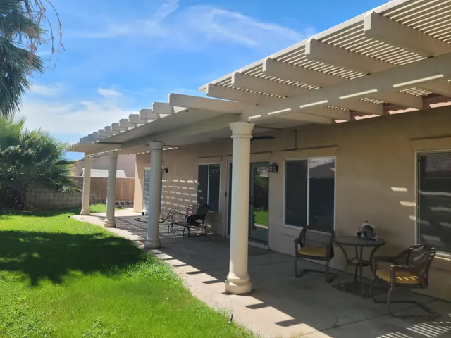 a view of a house with backyard and porch