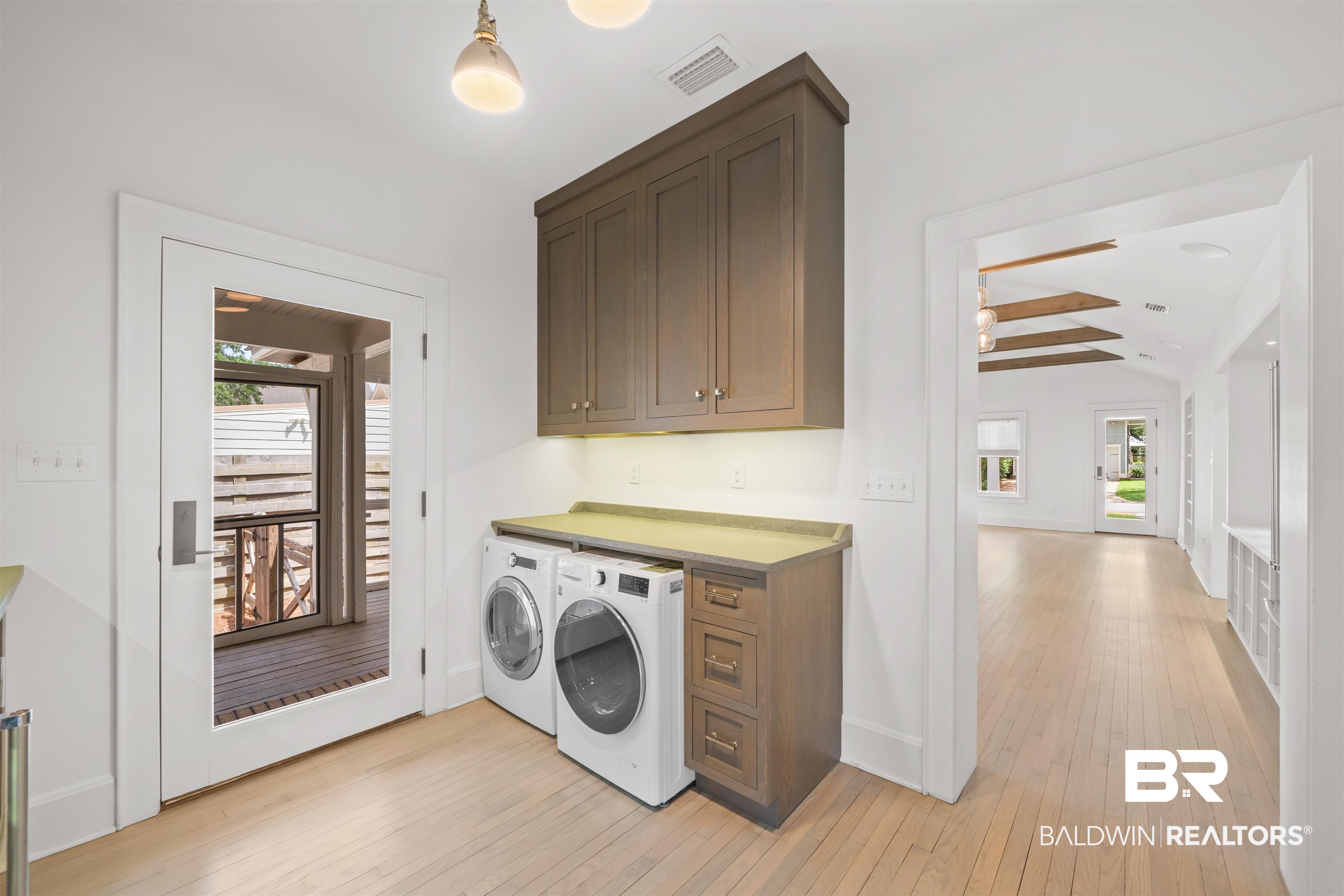 106 White Avenue Fairhope, AL 36532 - Photo 11 of 35 Laundry area with cabinet space, independent washer and dryer, and light wood-style flooring