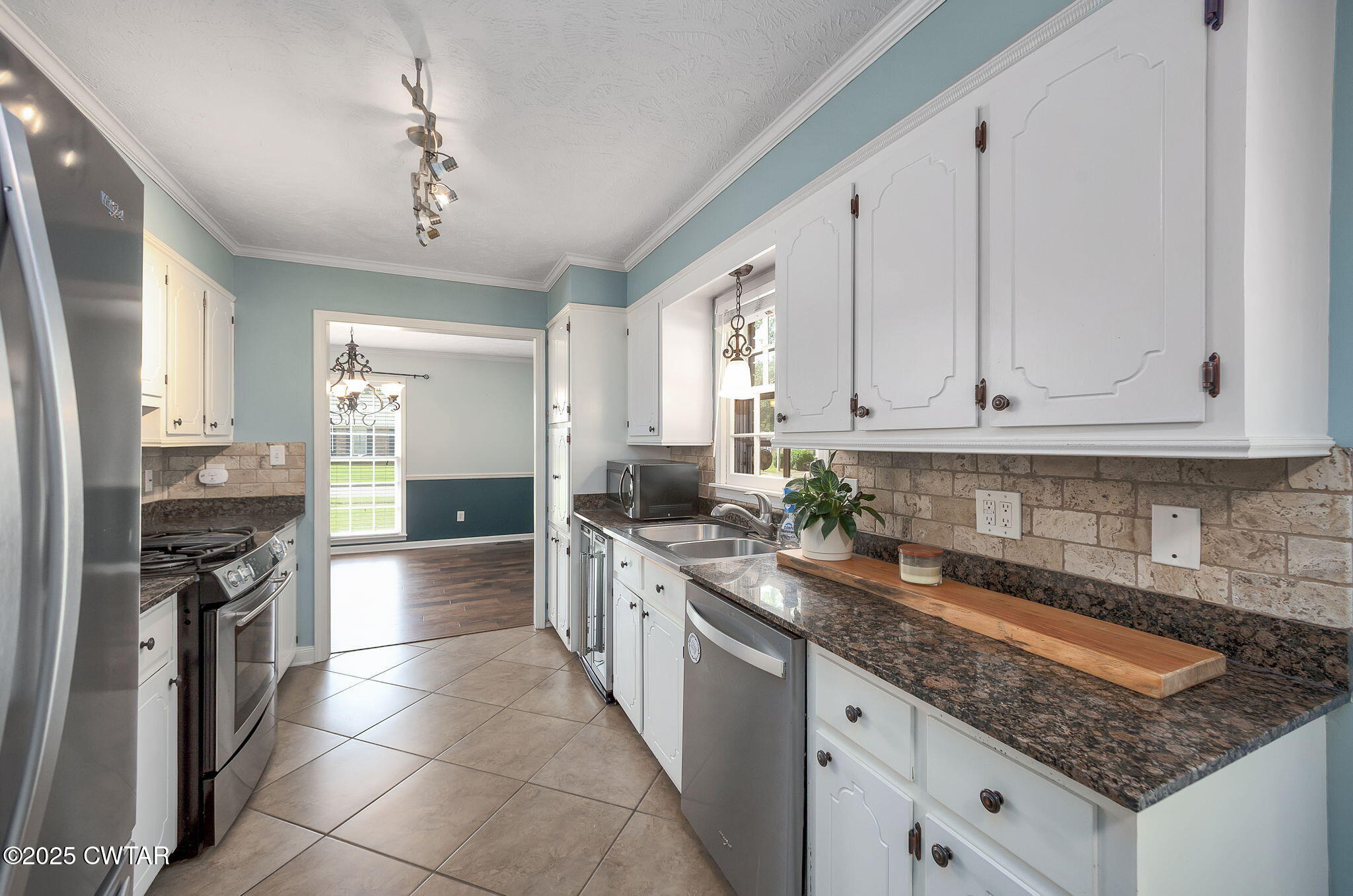 6 Jamestown Drive Jackson, TN 38305 - Photo 13 of 32 a kitchen with stainless steel appliances granite countertop a sink stove and refrigerator