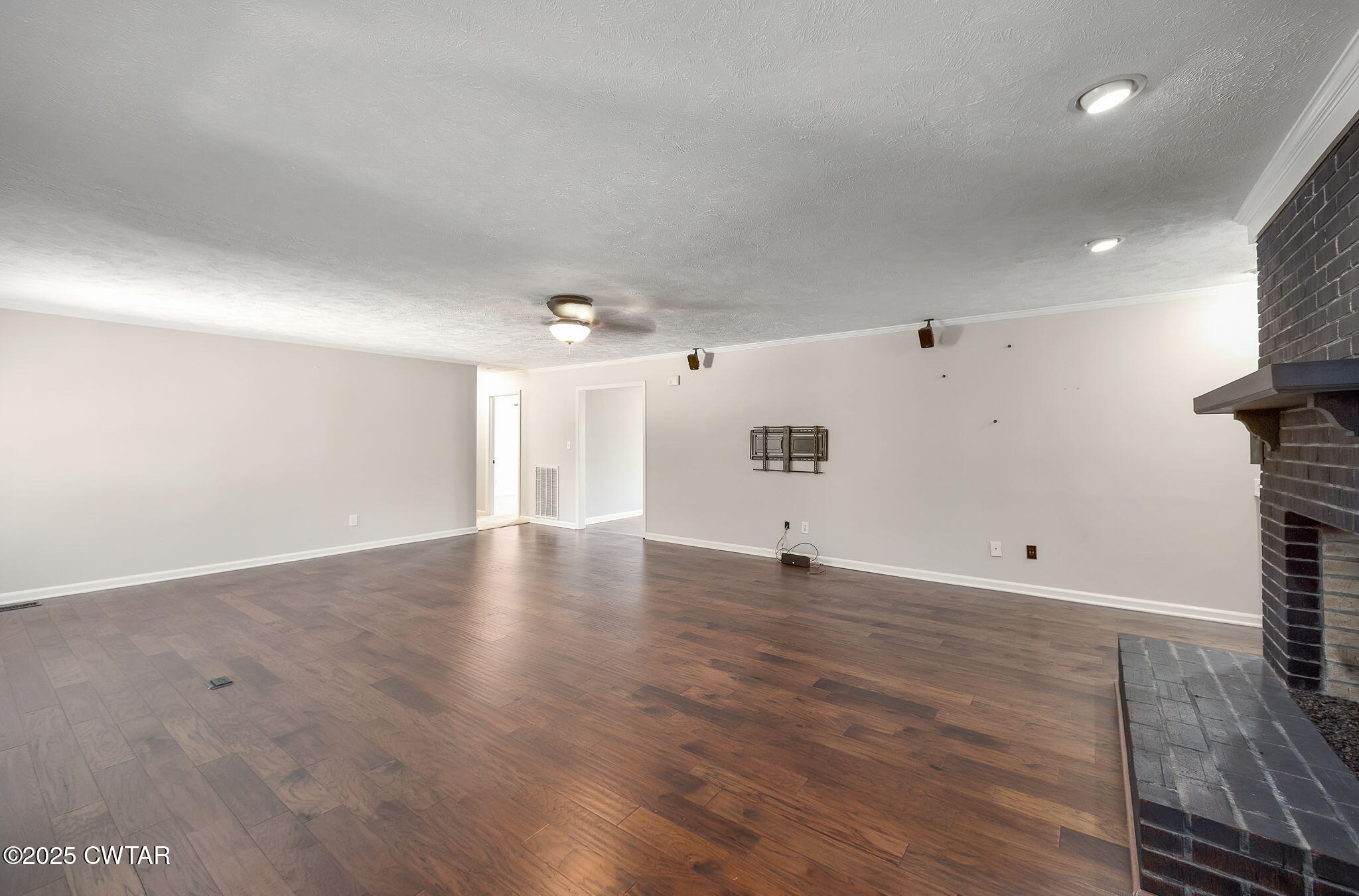 6 Jamestown Drive Jackson, TN 38305 - Photo 17 of 32 an empty room with wooden floor and windows