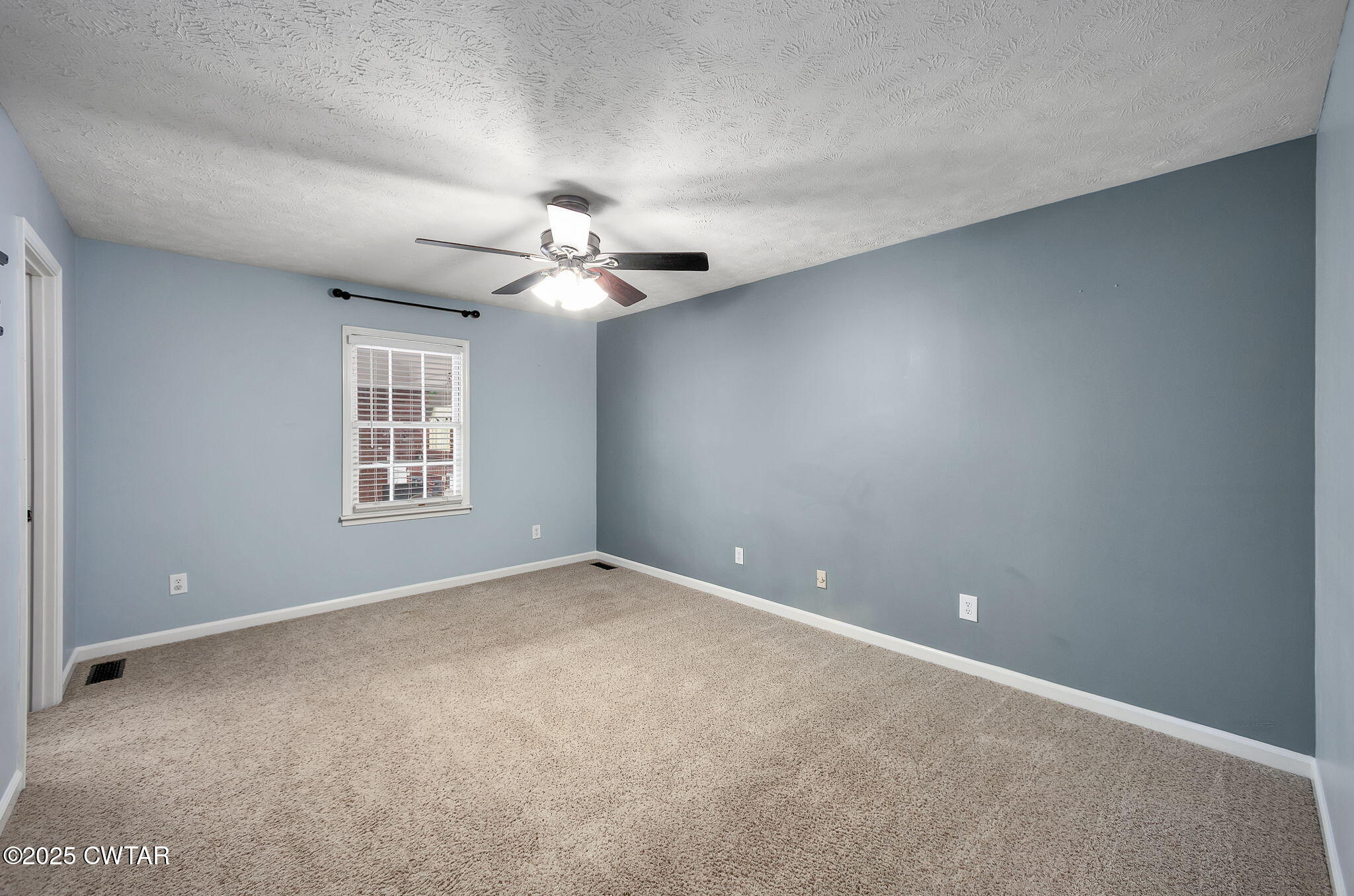 6 Jamestown Drive Jackson, TN 38305 - Photo 21 of 32 an empty room with windows and chandelier fan