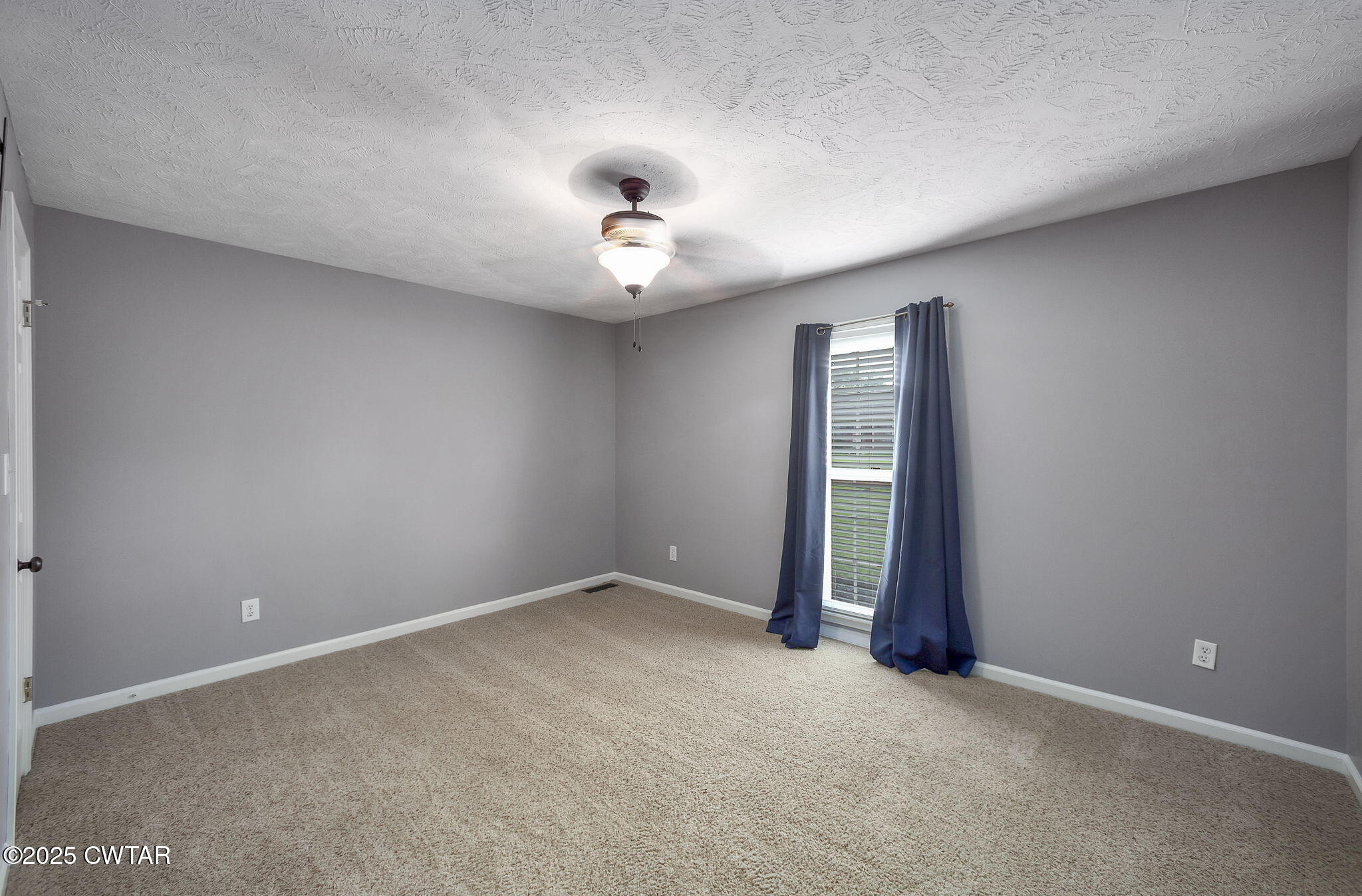 6 Jamestown Drive Jackson, TN 38305 - Photo 22 of 32 an empty room with chandelier fan and windows