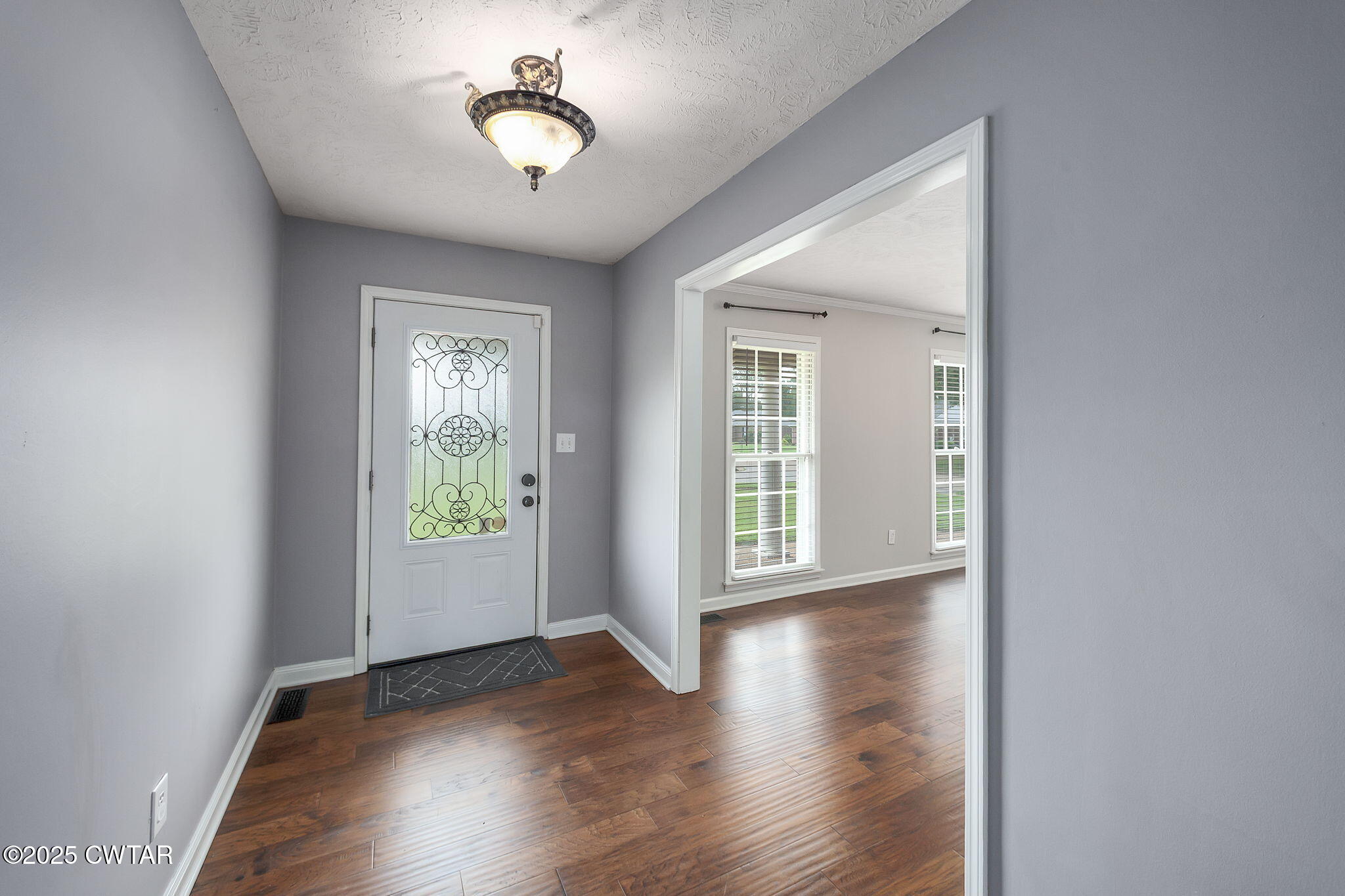 6 Jamestown Drive Jackson, TN 38305 - Photo 5 of 32 a view of an empty room with wooden floor and a window