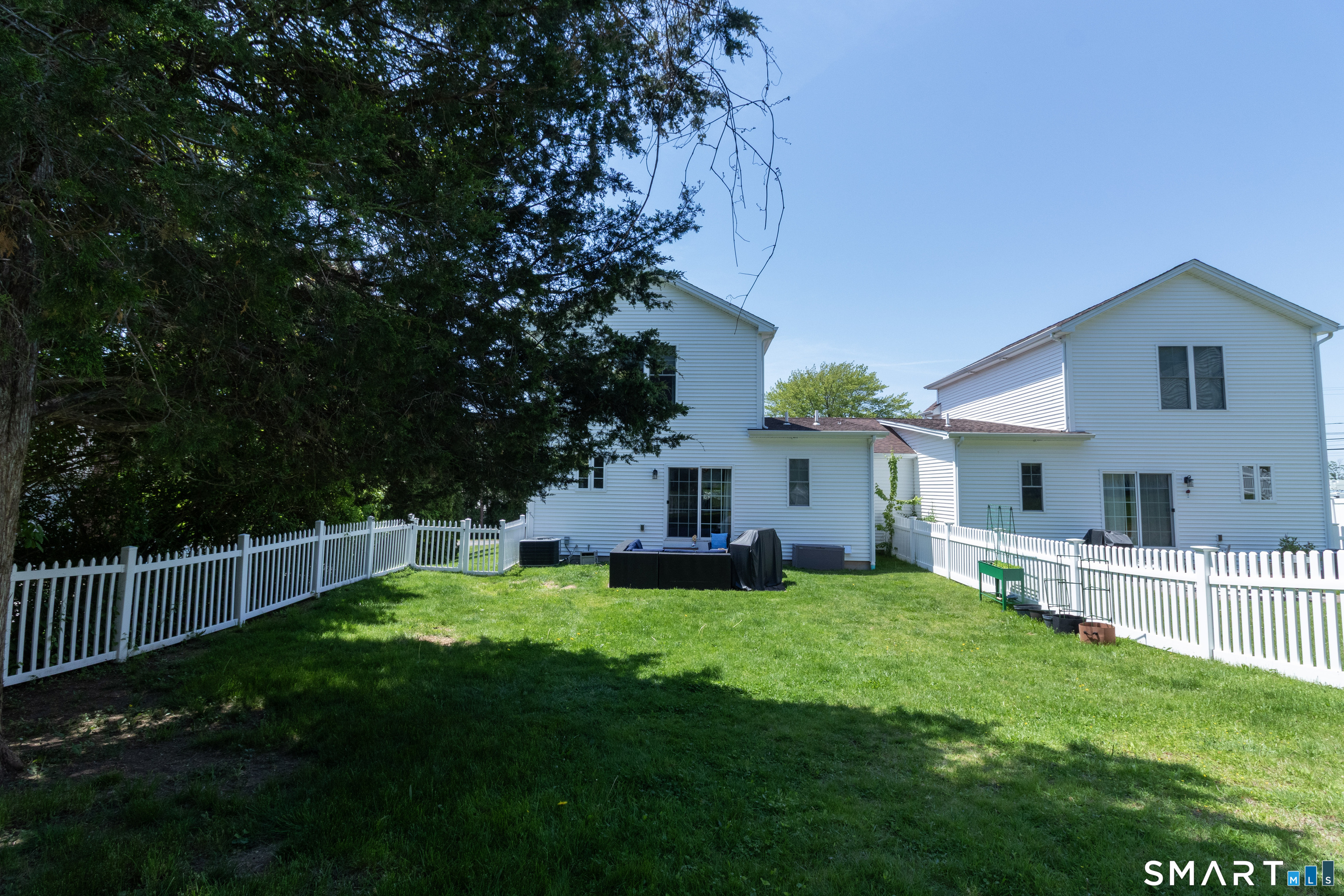 656 Bartholomew Road, Unit 656 Middletown, CT 06457 - Photo 5 of 27 a view of a house with a yard and a garden