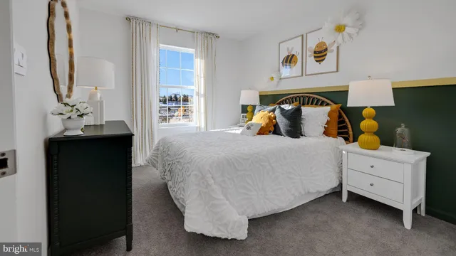 a bedroom with a bed and a mirror on the dresser