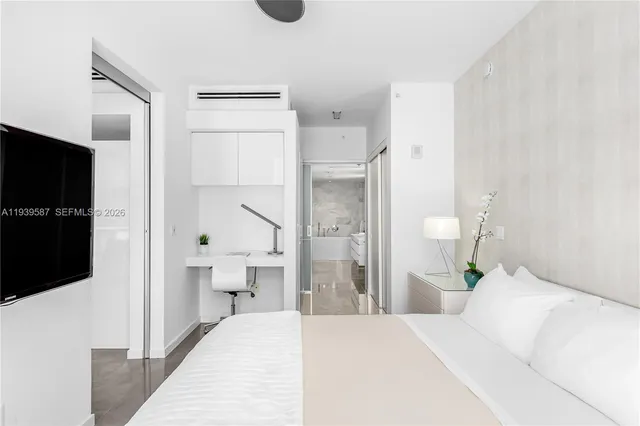 a bedroom with a bed and a view of bathroom