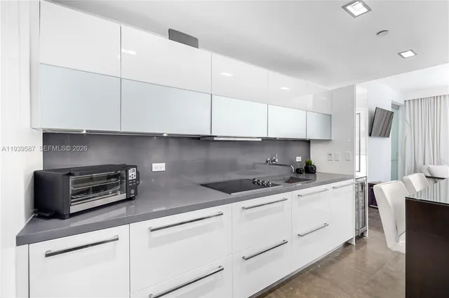 a kitchen with stainless steel appliances granite countertop a sink a stove and a granite counter tops