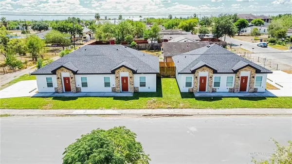 a aerial view of a house with a yard and plants