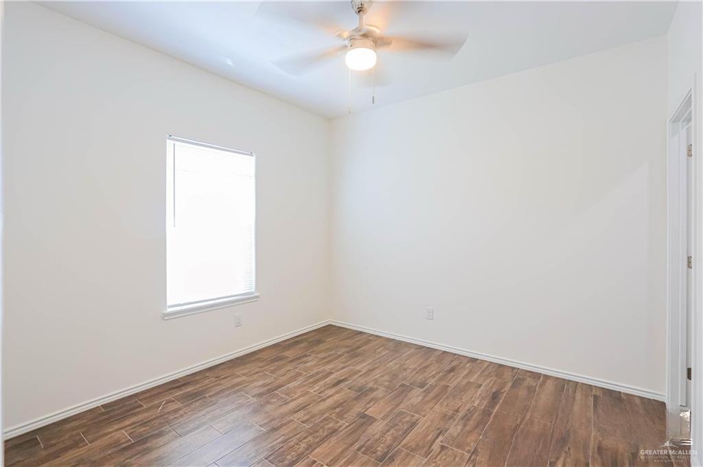 1046 Hidalgo Street Mercedes, TX 78570 - Photo 16 of 21 an empty room with a window and wooden floor