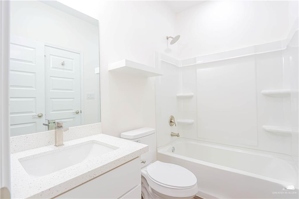 1046 Hidalgo Street Mercedes, TX 78570 - Photo 18 of 21 a bathroom with a sink a toilet and a bathtub