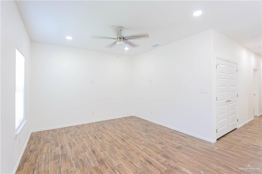 1046 Hidalgo Street Mercedes, TX 78570 - Photo 4 of 21 an empty room with a hardwood and ceiling fan