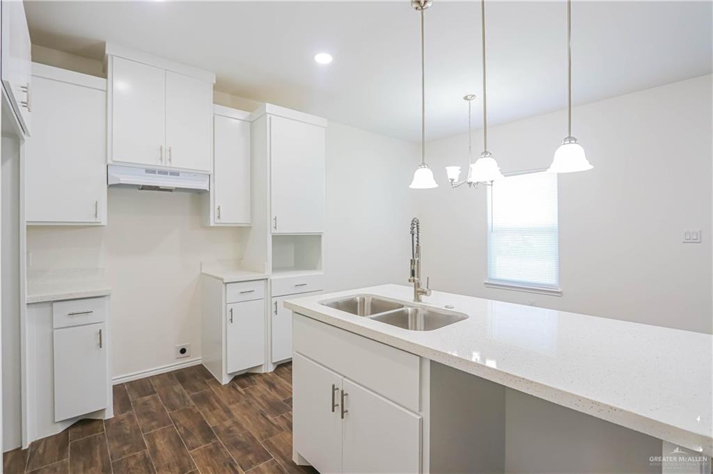1046 Hidalgo Street Mercedes, TX 78570 - Photo 8 of 21 a kitchen with a sink cabinets and window