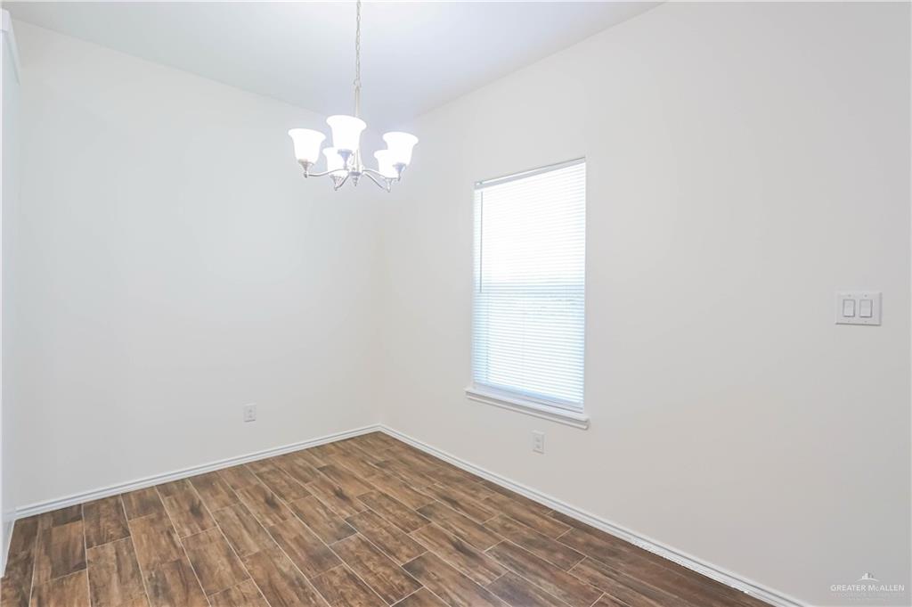 1046 Hidalgo Street Mercedes, TX 78570 - Photo 9 of 21 a view of a room with wooden floor and a fan