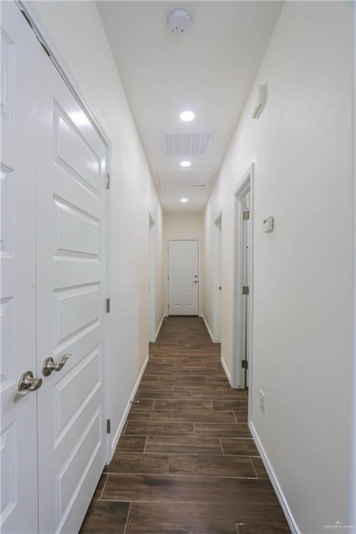 1046 Hidalgo Street Mercedes, TX 78570 - Photo 10 of 21 a view of a hallway with wooden floor and a staircase