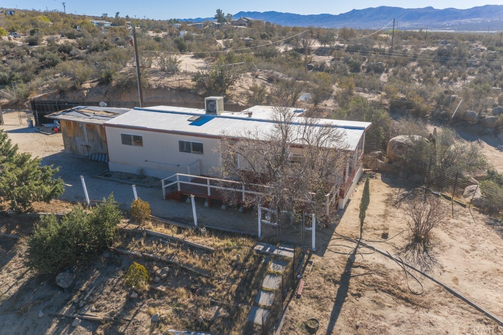 an aerial view of a house with a mountain