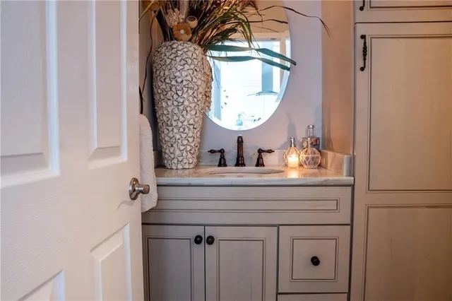 a bathroom with a sink mirror and vanity