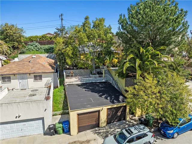 an aerial view of multiple houses with yard