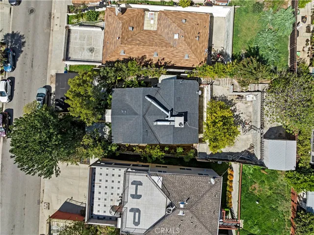 an aerial view of residential houses with outdoor space and street view