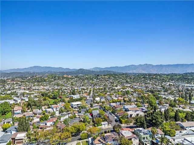 an empty room with wooden floor and window