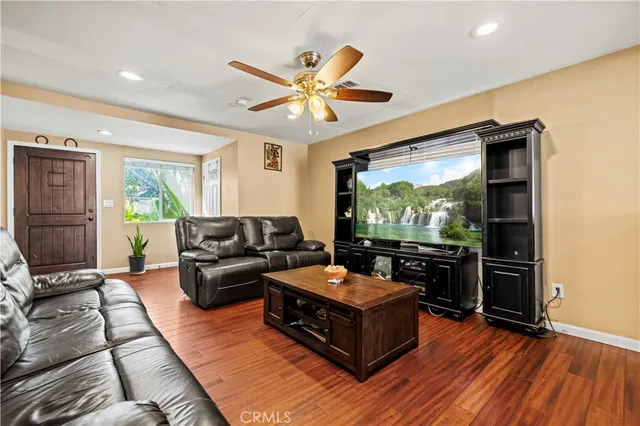 a kitchen with a sink appliances and wooden floor