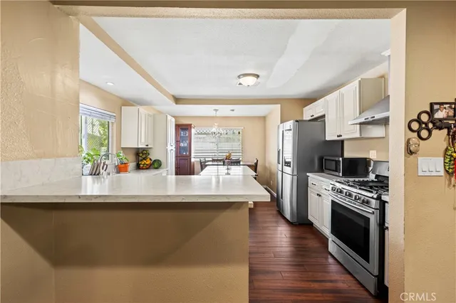 a kitchen with kitchen island a counter top space appliances and cabinets