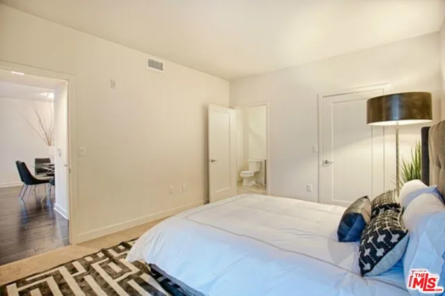 a bedroom with a bed and a mirror