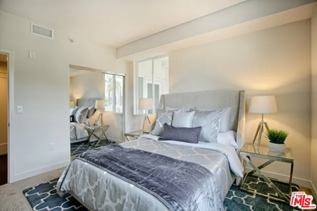 a bedroom with a bed and a mirror
