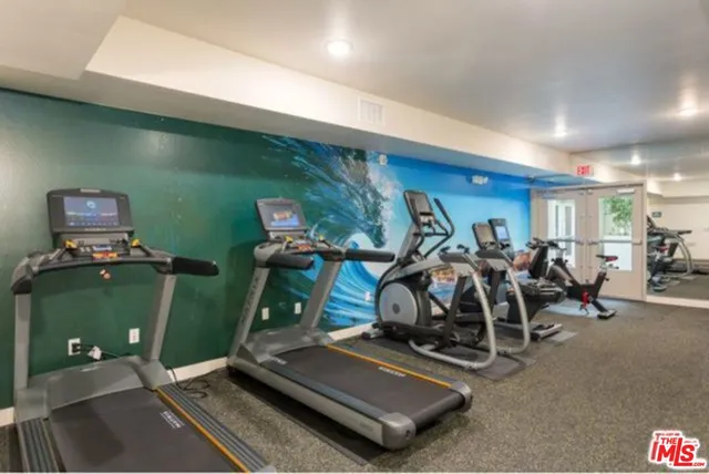 a room with gym equipment and a large window