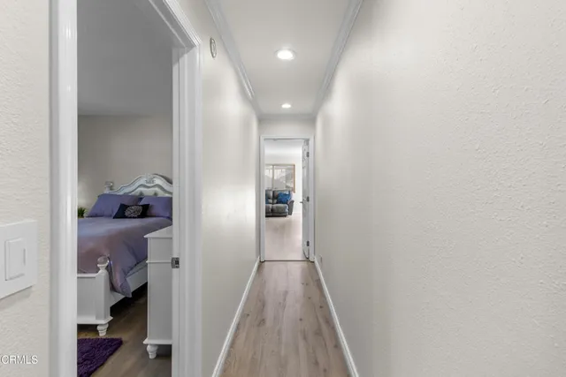 a view of hallway with wooden floor