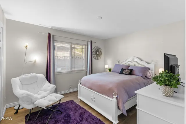 a spacious bedroom with a bed and a chair