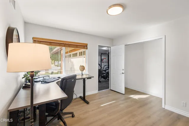 a view of a dining room with furniture and a window