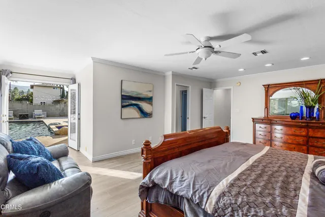 a bedroom with a bed and glass walk in closet