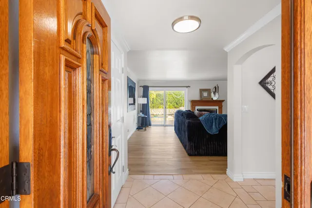 a view of a hallway with living room and furniture