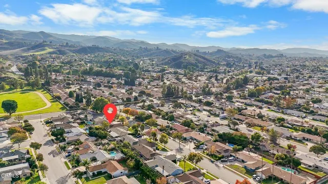an aerial view of residential house with outdoor space and mountain view