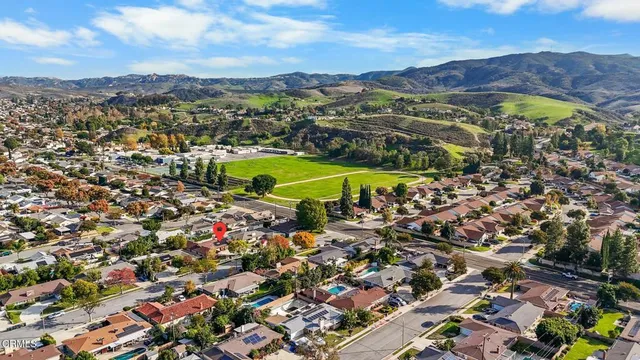 an aerial view of residential house with an outdoor space and seating