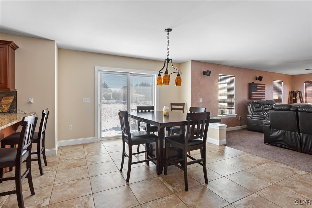 127 Fox Ridge Nazareth, PA 18064 - Photo 12 of 48 a view of a dining room and livingroom with furniture wooden floor a rug a painting and a chandelier