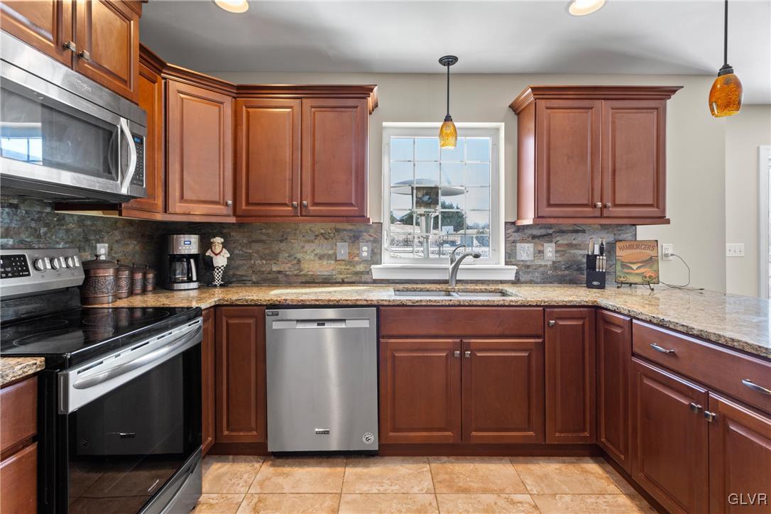 127 Fox Ridge Nazareth, PA 18064 - Photo 10 of 48 a kitchen with granite countertop a sink stainless steel appliances and cabinets