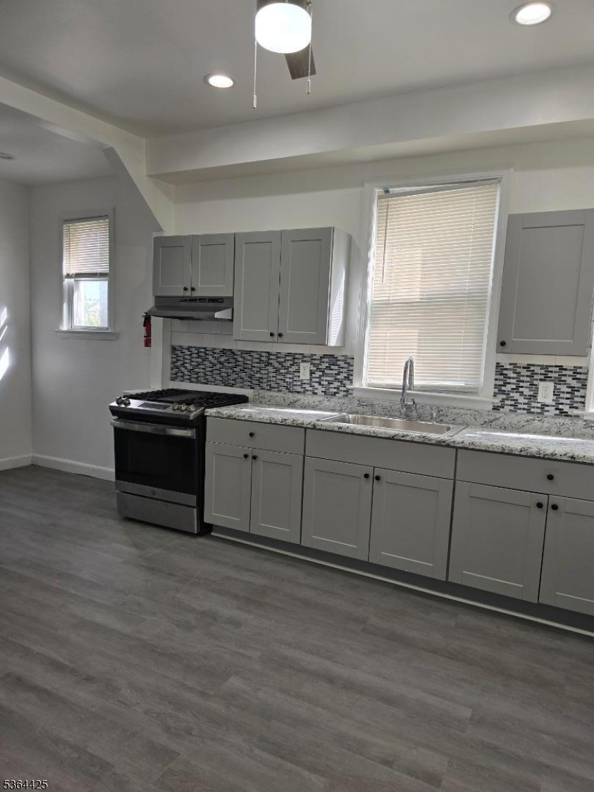 782 Bergen Street, Unit 3 Newark, NJ 07108 - Photo 6 of 20 a kitchen with stainless steel appliances granite countertop a sink a stove and a wooden floors