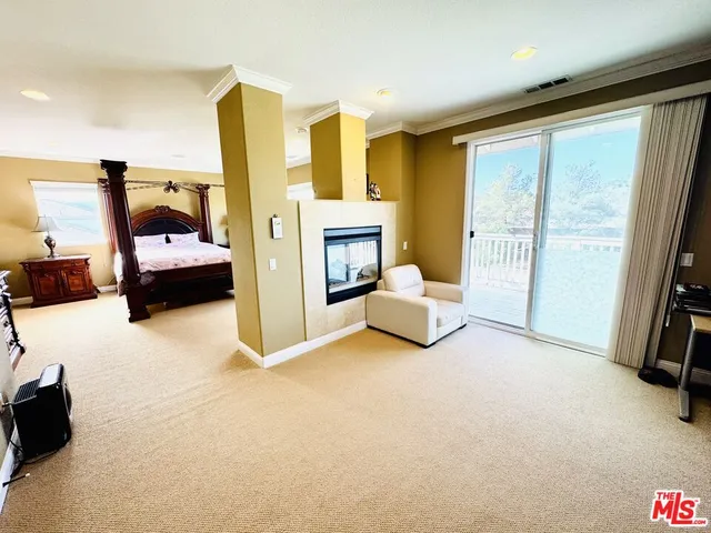 a bedroom with furniture and a large window