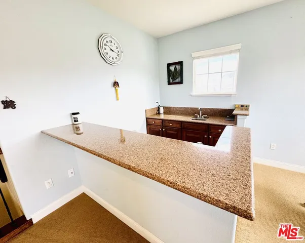 a kitchen with kitchen island a counter top space and a window