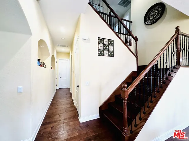 a view of entryway and hall with wooden floor