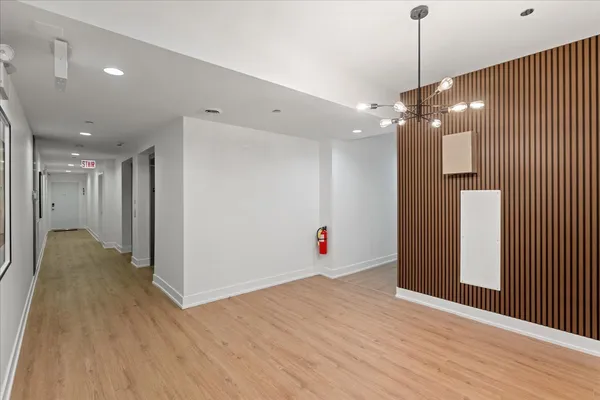 a view of an empty room with wooden floor