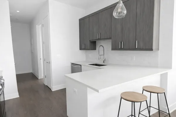 a kitchen with a table chairs and a refrigerator
