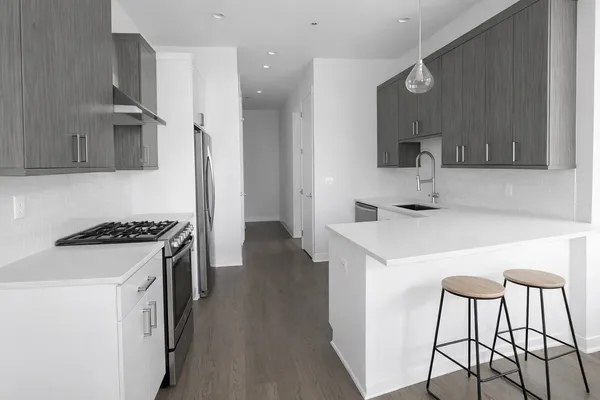a kitchen with a sink a stove and a refrigerator