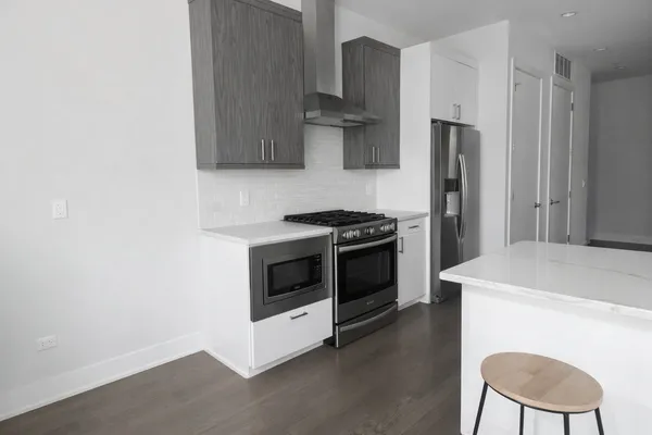 a kitchen with stainless steel appliances a stove a sink and a refrigerator