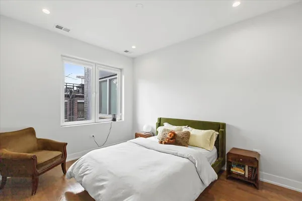 a bedroom with a bed and chair