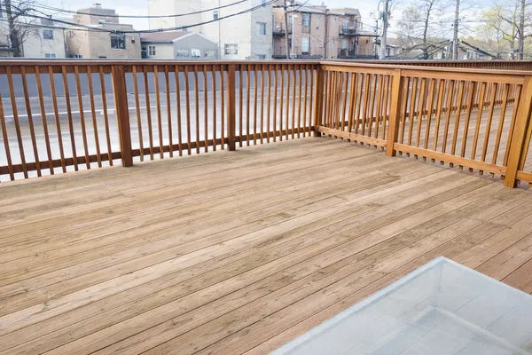 a view of a balcony with wooden floor