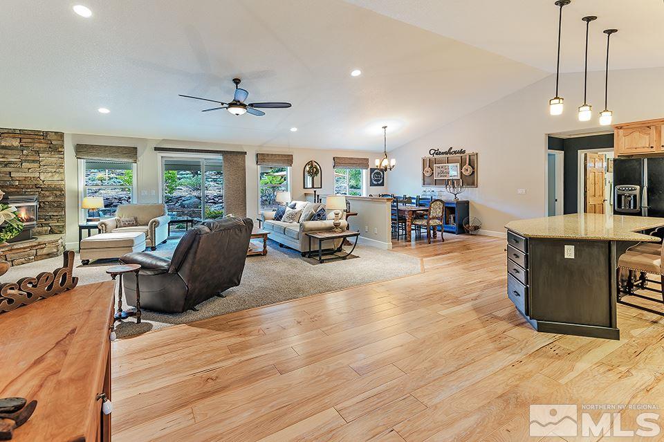 2850 Bullfrog Road Reno, NV 89521 - Photo 3 of 25 a living room with furniture a fireplace and a dining table with wooden floor