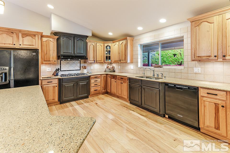 2850 Bullfrog Road Reno, NV 89521 - Photo 9 of 25 a kitchen with stainless steel appliances granite countertop a sink a stove and refrigerator
