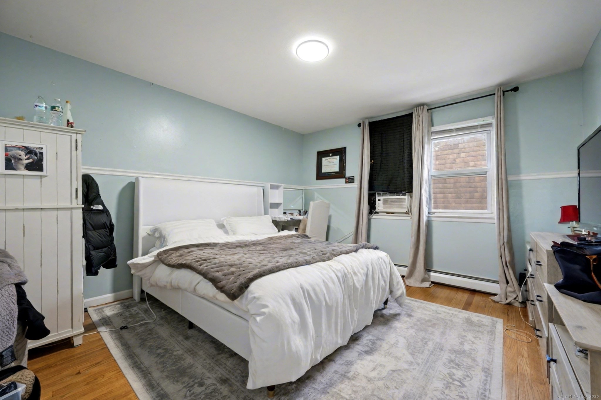 720 Queen Street Bridgeport, CT 06606 - Photo 13 of 36 a bedroom with a bed and a dresser